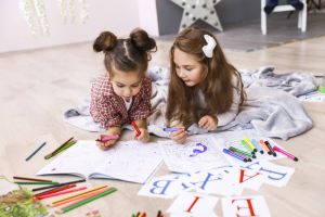 Children painting and learning english alphabet