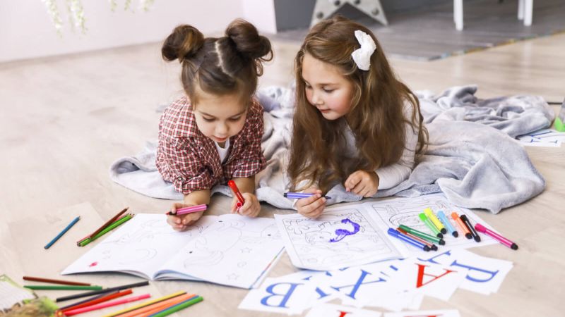 Children painting and learning english alphabet
